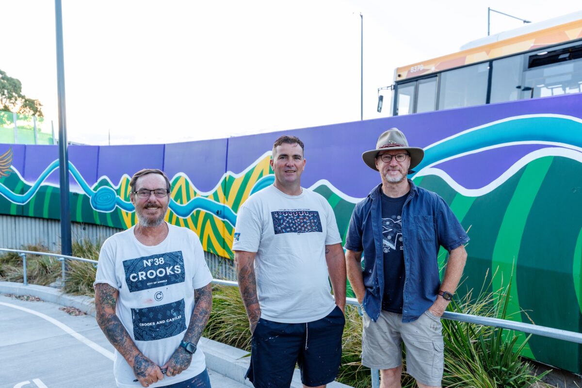 Bulleen Park and Ride Mural, Bulleen. Artists pictured Left to Right: Ash Thomas (Yorta Yorta/Wiradjuri people), Jeza (Yorta Yorta/Wemba Wemba people) and Sean Miller (Gamilaroi people). Photograph: Benny Clark (Djaambi Photography)