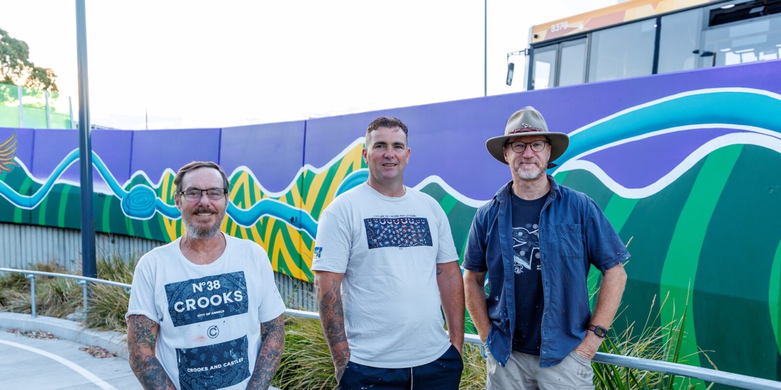 Bulleen Park and Ride Mural, Bulleen. Artists pictured Left to Right: Ash Thomas (Yorta Yorta/Wiradjuri people), Jeza (Yorta Yorta/Wemba Wemba people) and Sean Miller (Gamilaroi people). Photograph: Benny Clark (Djaambi Photography)